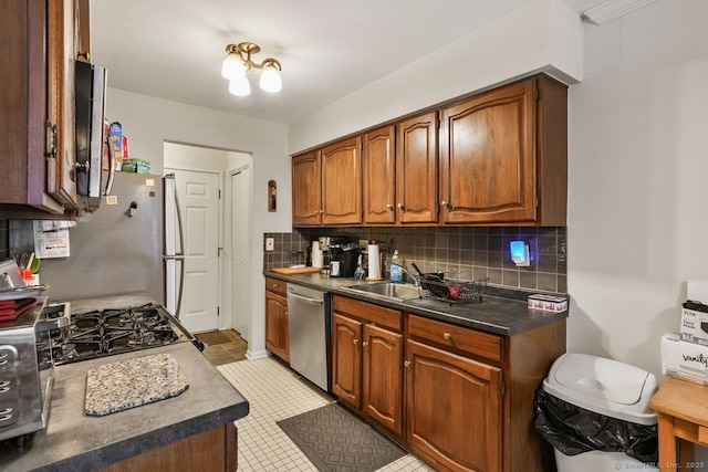 kitchen featuring sink, backsplash, dishwasher, and range