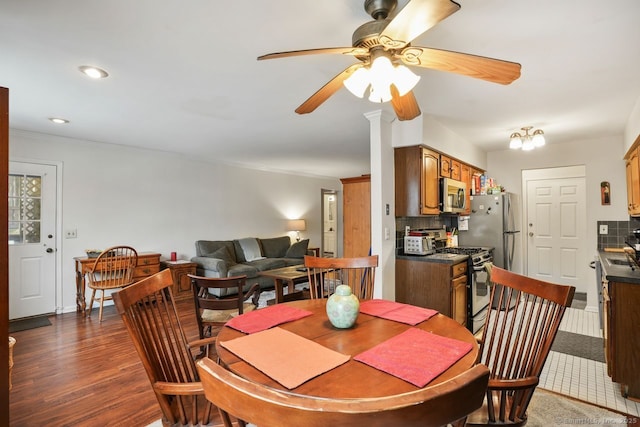 dining area with dark hardwood / wood-style flooring, ornamental molding, and ceiling fan