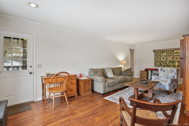 living room with wood-type flooring and ornamental molding