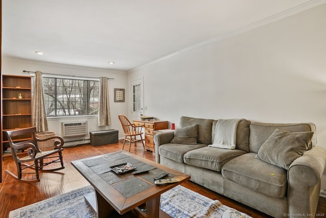 living room featuring a wall mounted air conditioner, ornamental molding, hardwood / wood-style floors, and a baseboard radiator