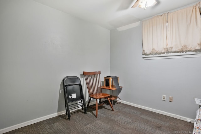 living area with dark colored carpet and ceiling fan