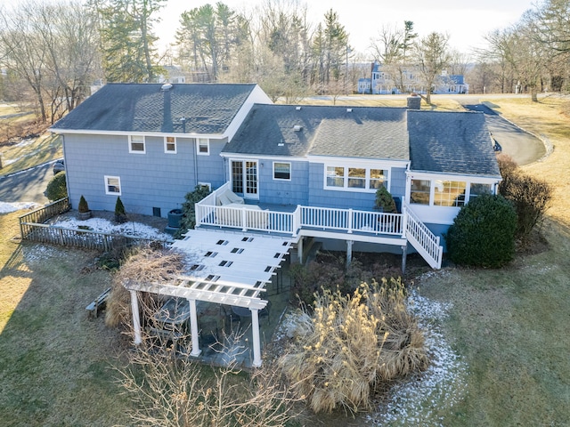 rear view of house featuring a pergola and a deck