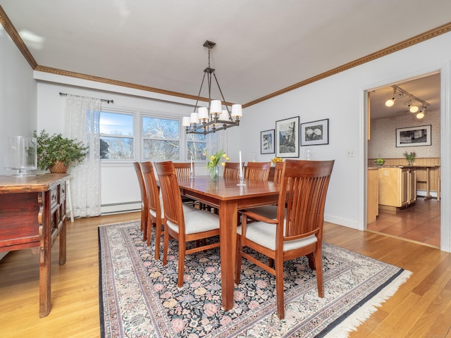 dining area with crown molding, a baseboard radiator, wood-type flooring, and a chandelier