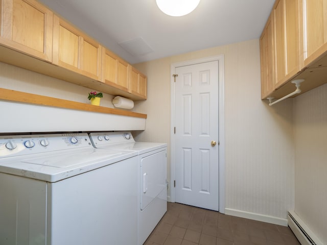 clothes washing area with cabinets, a baseboard radiator, and washing machine and dryer