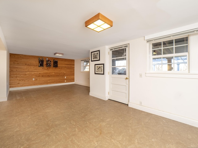 empty room featuring wooden walls