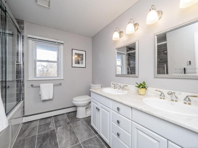 full bathroom featuring shower / bath combination with glass door, a baseboard radiator, vanity, and toilet