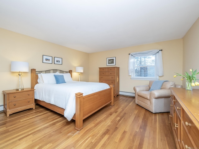 bedroom featuring a baseboard radiator and light hardwood / wood-style floors