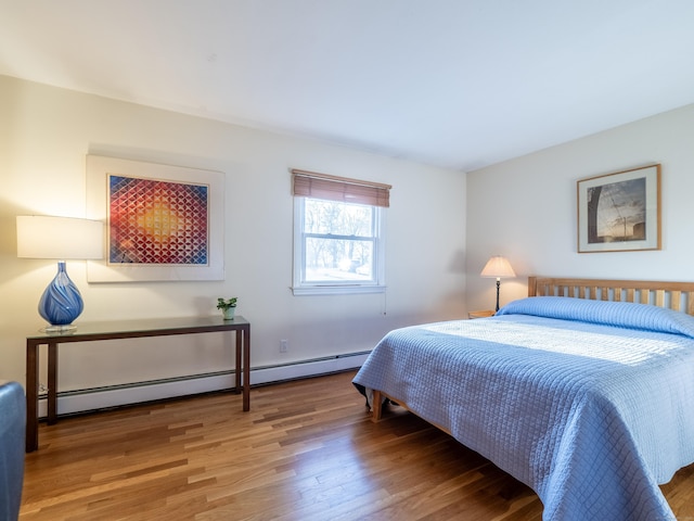 bedroom featuring hardwood / wood-style floors and a baseboard radiator