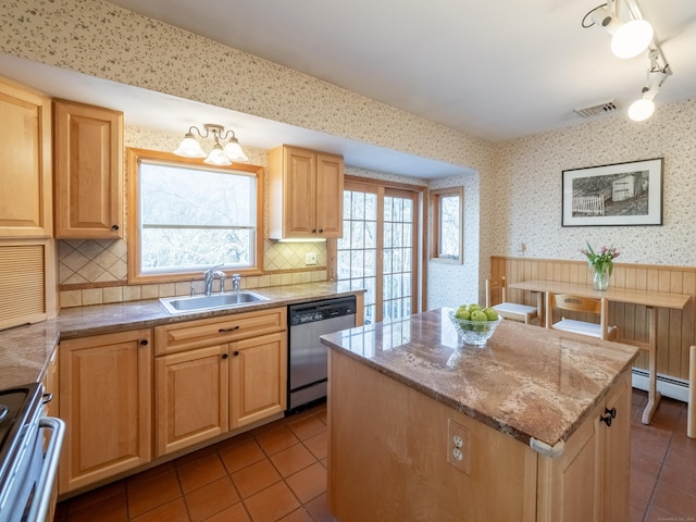 kitchen featuring sink, light tile patterned floors, stainless steel dishwasher, a kitchen island, and stove