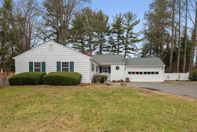 view of front of home with a garage and a front lawn