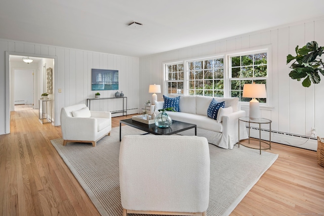 living room featuring a baseboard radiator and light hardwood / wood-style floors