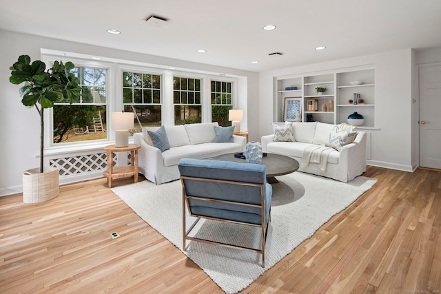 living room with a healthy amount of sunlight and light wood-type flooring