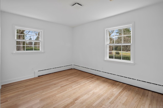 spare room featuring light hardwood / wood-style flooring and a baseboard radiator