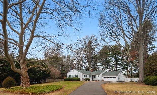 single story home with a garage and a front yard