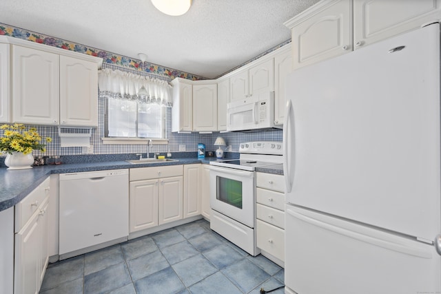 kitchen with tasteful backsplash, white cabinetry, sink, white appliances, and a textured ceiling