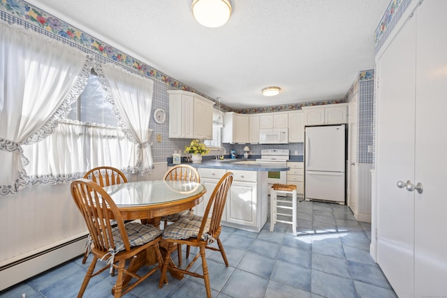 interior space featuring a baseboard heating unit, light tile patterned floors, and a textured ceiling