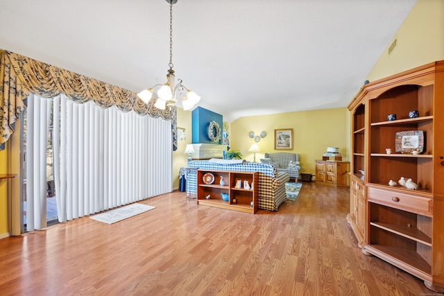 dining area featuring vaulted ceiling, a notable chandelier, and light wood-type flooring