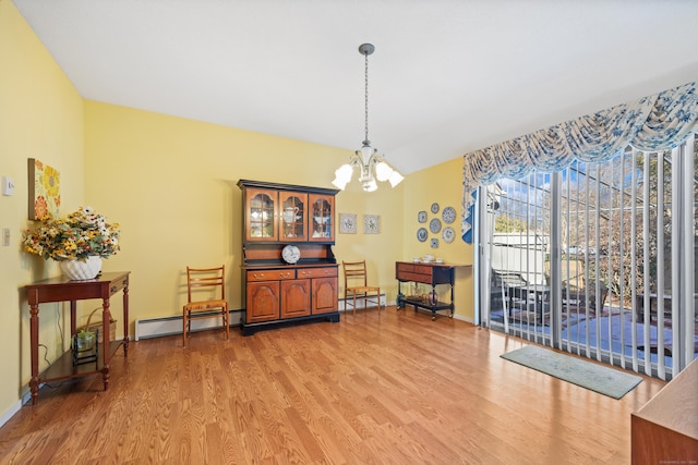 interior space featuring hardwood / wood-style flooring, a baseboard radiator, and a chandelier