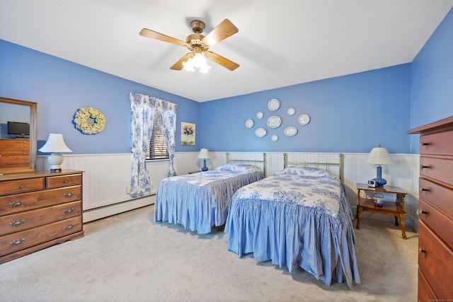 bedroom with light carpet, a baseboard heating unit, and ceiling fan