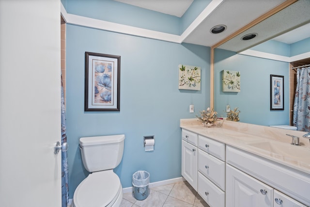 bathroom with vanity, tile patterned floors, and toilet