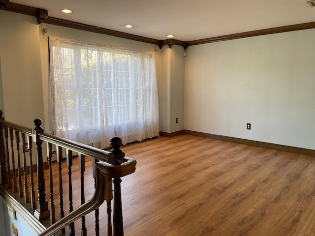 empty room with visible vents, baseboards, ornamental molding, recessed lighting, and wood finished floors