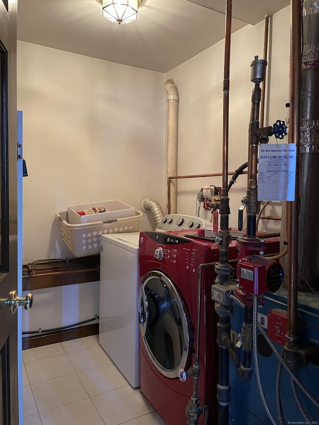 laundry room featuring independent washer and dryer, laundry area, and tile patterned flooring