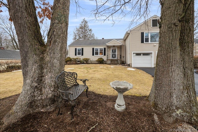 view of front of home featuring a garage and a front lawn