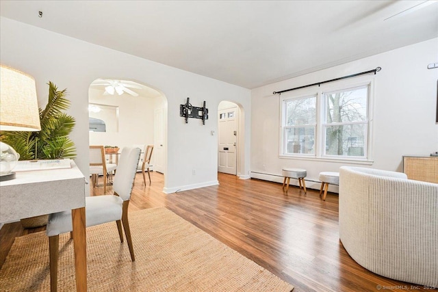 dining room with hardwood / wood-style flooring and a baseboard radiator