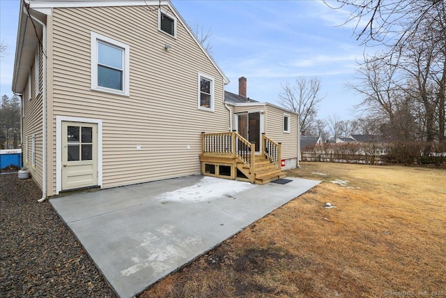 rear view of property featuring central AC unit and a patio