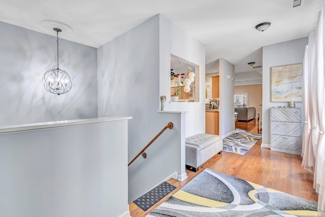 interior space with a notable chandelier and light hardwood / wood-style flooring