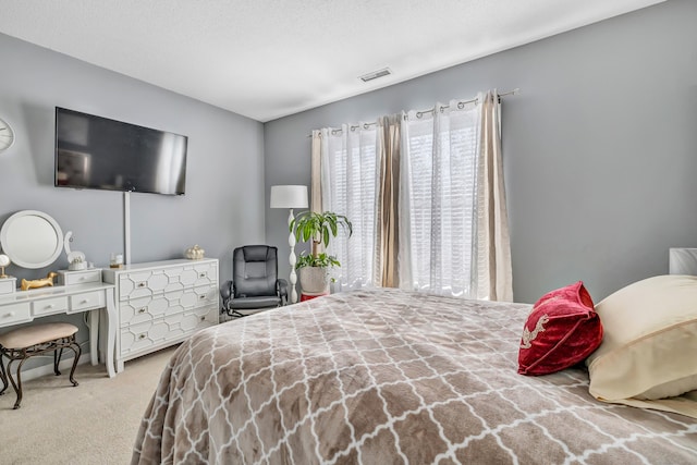 carpeted bedroom featuring a textured ceiling