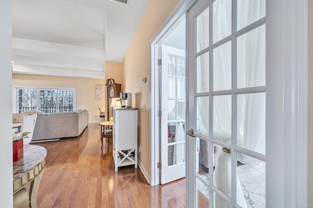 corridor featuring light hardwood / wood-style floors