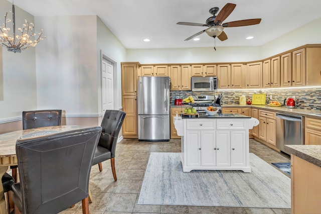 kitchen with decorative light fixtures, a center island, light brown cabinets, stainless steel appliances, and backsplash