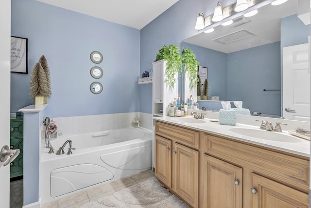 bathroom with vanity, a tub, and tile patterned floors