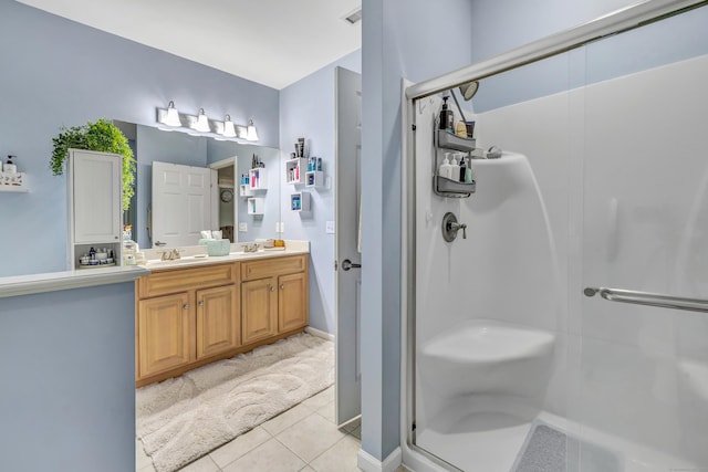 bathroom featuring vanity, tile patterned floors, and walk in shower