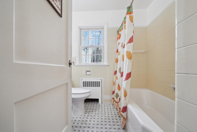 bathroom with radiator, tile walls, shower / bathtub combination with curtain, and toilet