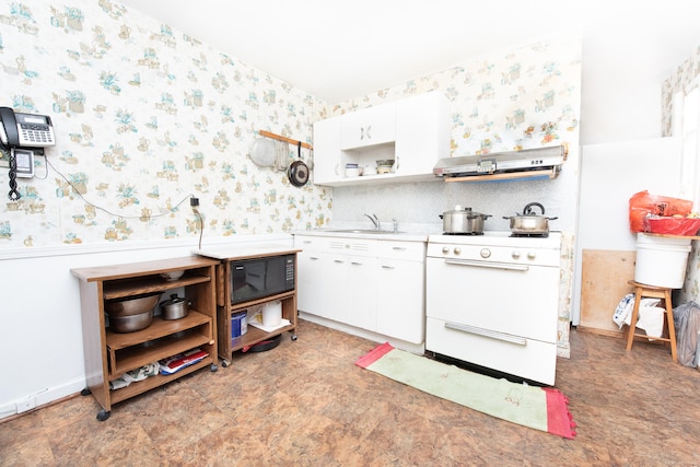 kitchen with sink, white range, and white cabinets