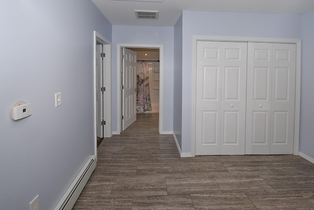 hall featuring a baseboard heating unit