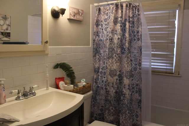 full bathroom with vanity, tile walls, shower / bath combination with curtain, and toilet