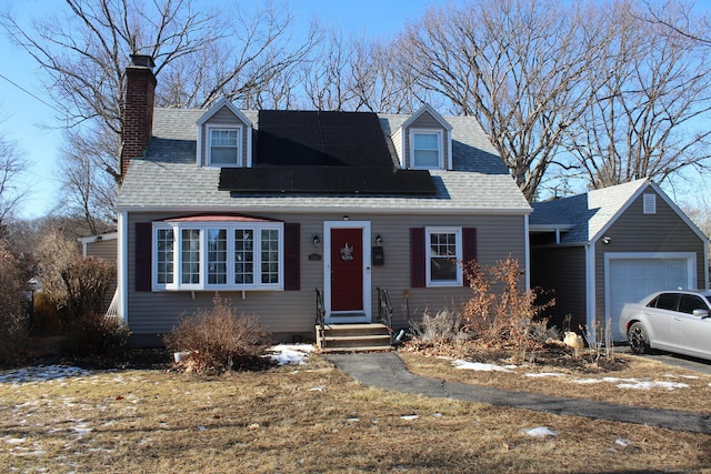 cape cod home featuring a garage