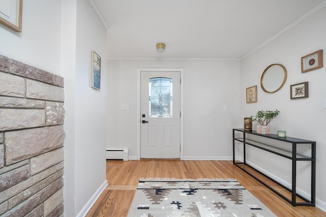 entrance foyer with crown molding, baseboard heating, and light hardwood / wood-style floors