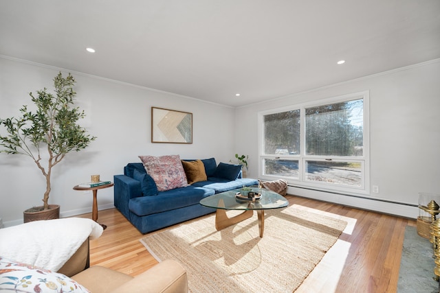 living room featuring wood-type flooring, ornamental molding, and baseboard heating