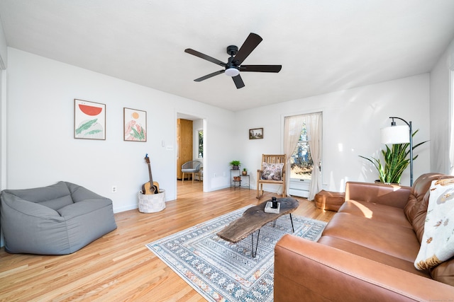 living room featuring wood-type flooring and ceiling fan