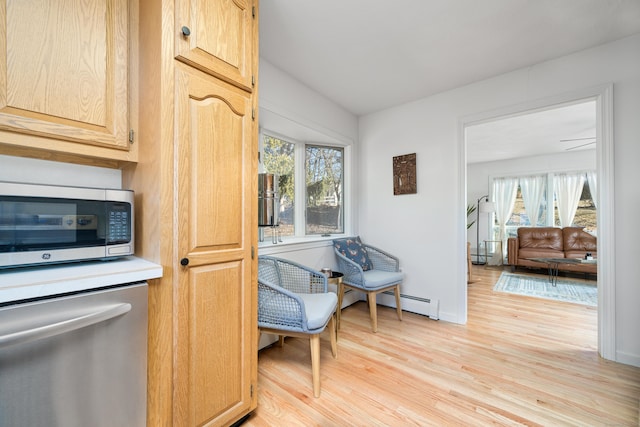 kitchen with stainless steel appliances, a wealth of natural light, light brown cabinetry, and light wood-type flooring