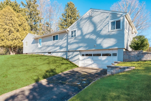 view of front facade with a garage and a front lawn