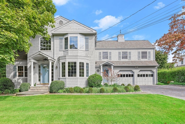 view of front of property with a garage and a front yard