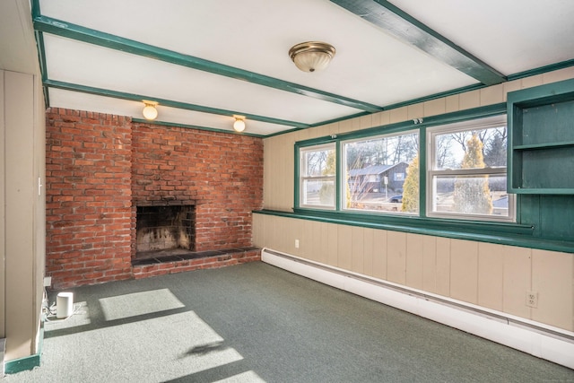 unfurnished living room featuring a fireplace, a baseboard radiator, brick wall, beam ceiling, and carpet