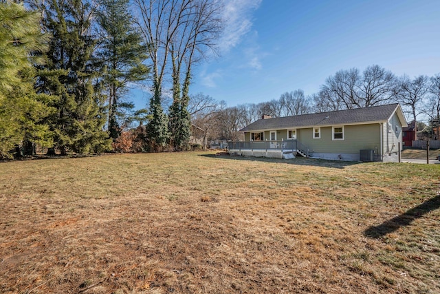 view of yard featuring a wooden deck and central air condition unit