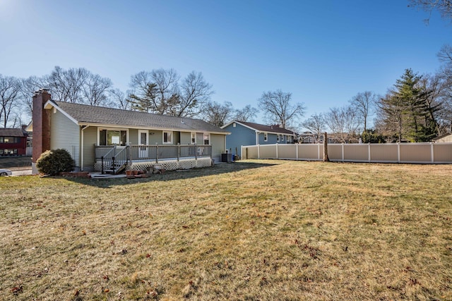 rear view of property featuring a yard, cooling unit, and covered porch