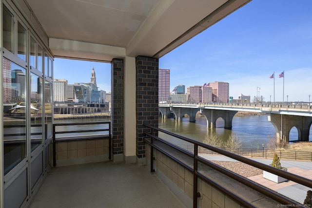 balcony with a view of city and a water view